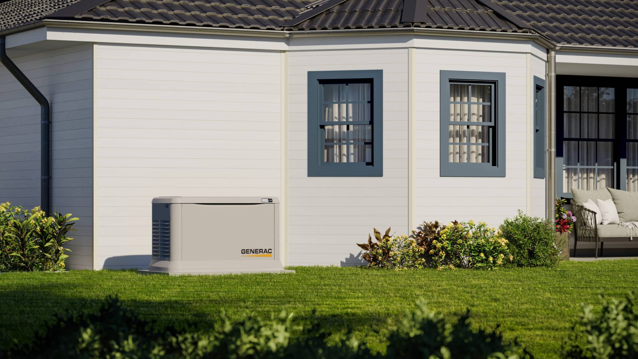 A standby generator sits on a concrete pad next to a white house with blue-trimmed windows, surrounded by a neatly kept lawn and small shrubs—a reminder of why many homeowners choose to shop electric generators for peace of mind.